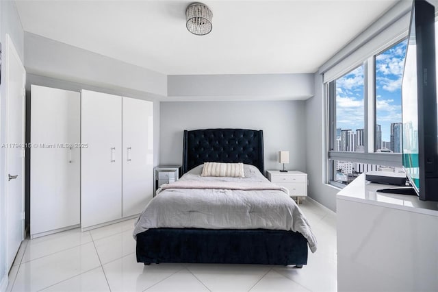 bedroom featuring light tile patterned floors and a closet