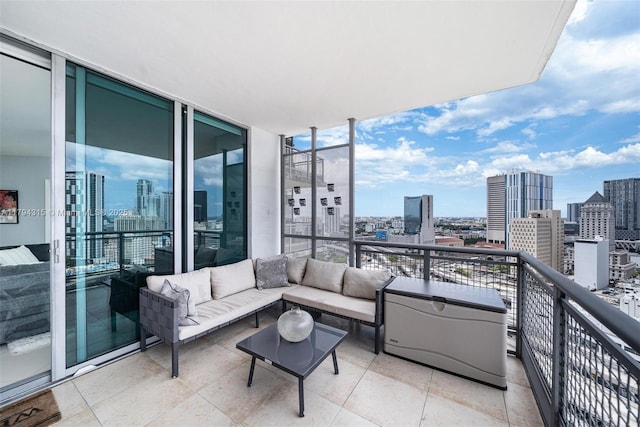 balcony with an outdoor living space and a city view