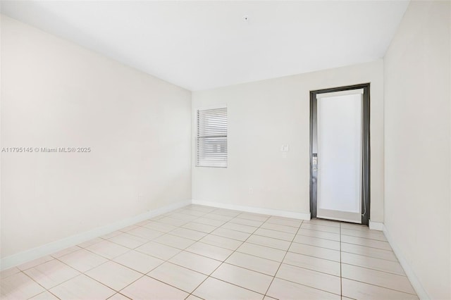 7865 NW 104th Ave Unit 33, Doral, FL 33178 - empty room featuring baseboards and light tile patterned floors