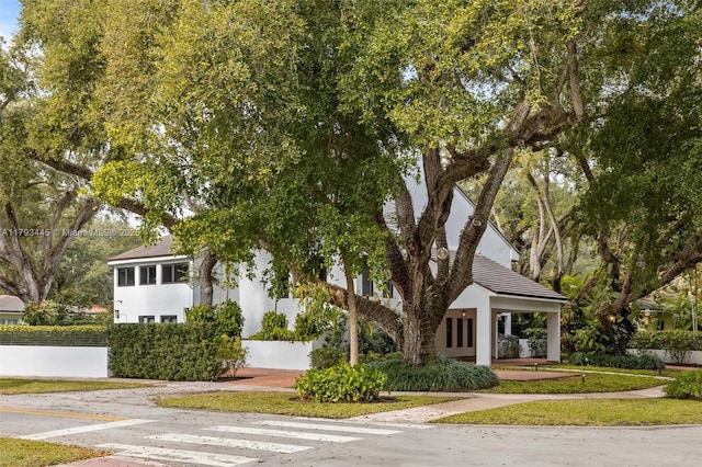 view of front facade with stucco siding and a tile roof