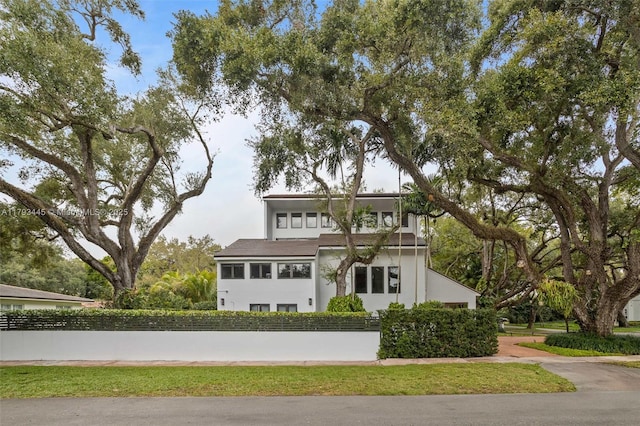 view of front of property with fence and stucco siding
