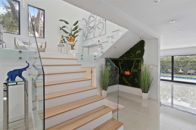 stairs with tile patterned flooring and recessed lighting