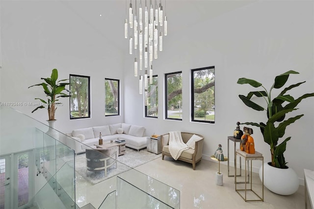 living room featuring french doors, a high ceiling, and baseboards