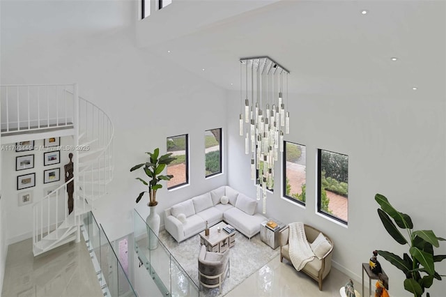 living area featuring marble finish floor, stairs, recessed lighting, baseboards, and a towering ceiling