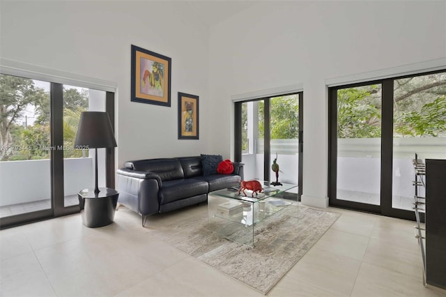 living room featuring high vaulted ceiling and light tile patterned flooring