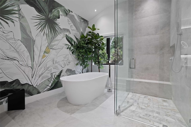 full bathroom featuring recessed lighting, marble finish floor, a freestanding bath, and a stall shower