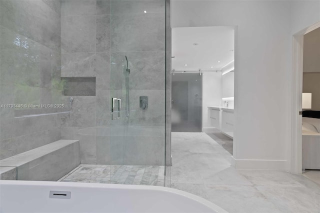 full bath featuring vanity, a freestanding bath, and a shower stall