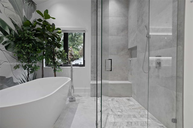 bathroom featuring a freestanding bath and a stall shower