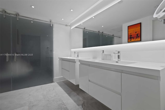 full bathroom featuring double vanity, a sink, walk in shower, and recessed lighting