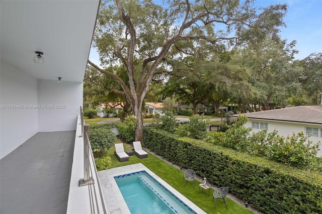 view of pool featuring a lawn and a pool