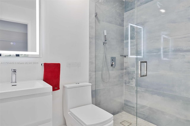 full bathroom with vanity, a shower stall, and toilet