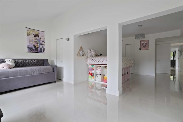 living area featuring baseboards and tile patterned floors