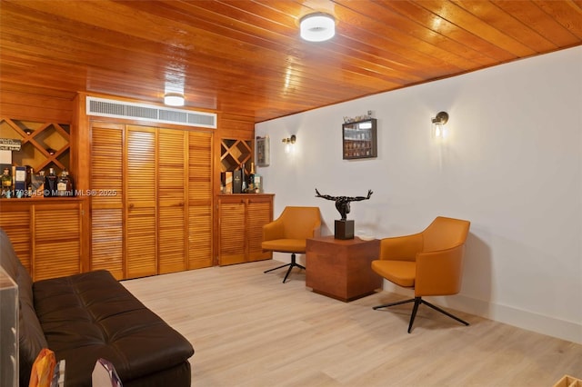 sitting room featuring wooden ceiling and wood finished floors