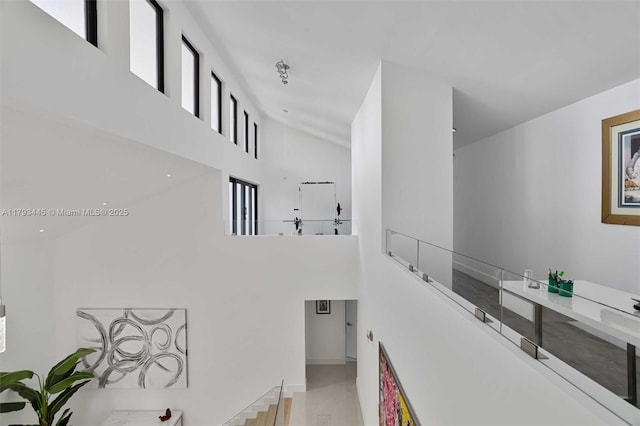 interior space with a high ceiling and baseboards