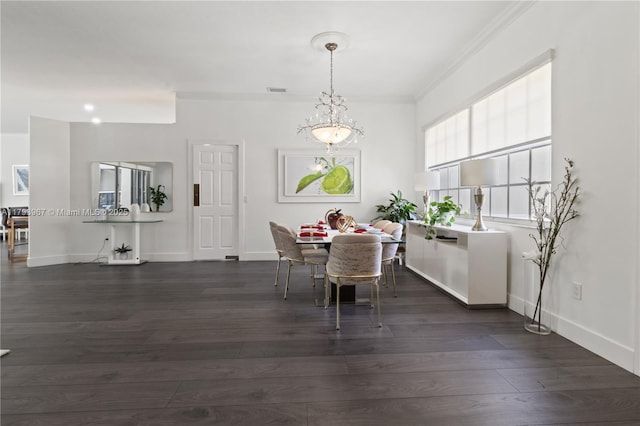 dining room with crown molding, dark wood finished floors, and baseboards