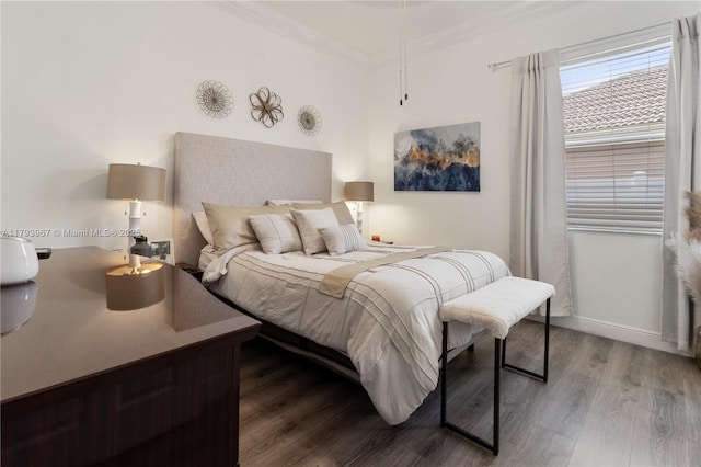 bedroom featuring ornamental molding and wood finished floors
