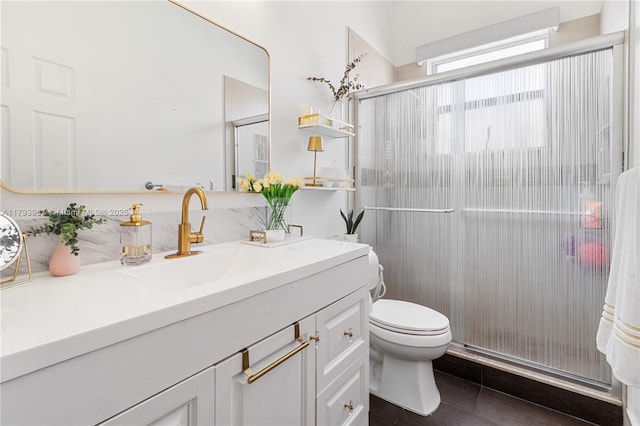 bathroom featuring vanity, tile patterned flooring, a stall shower, and toilet
