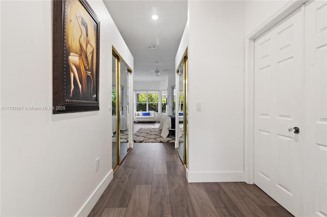 hall featuring baseboards, recessed lighting, dark wood-style flooring, and visible vents