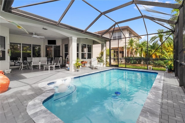 outdoor pool featuring a patio, ceiling fan, a lanai, and outdoor dining area