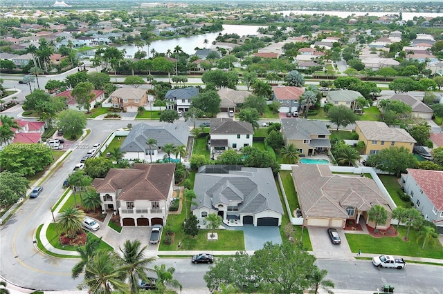 birds eye view of property with a residential view and a water view