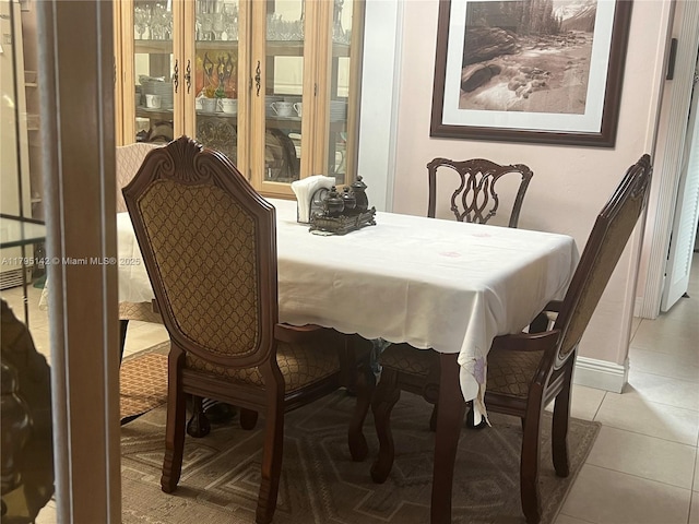 tiled dining room with baseboards