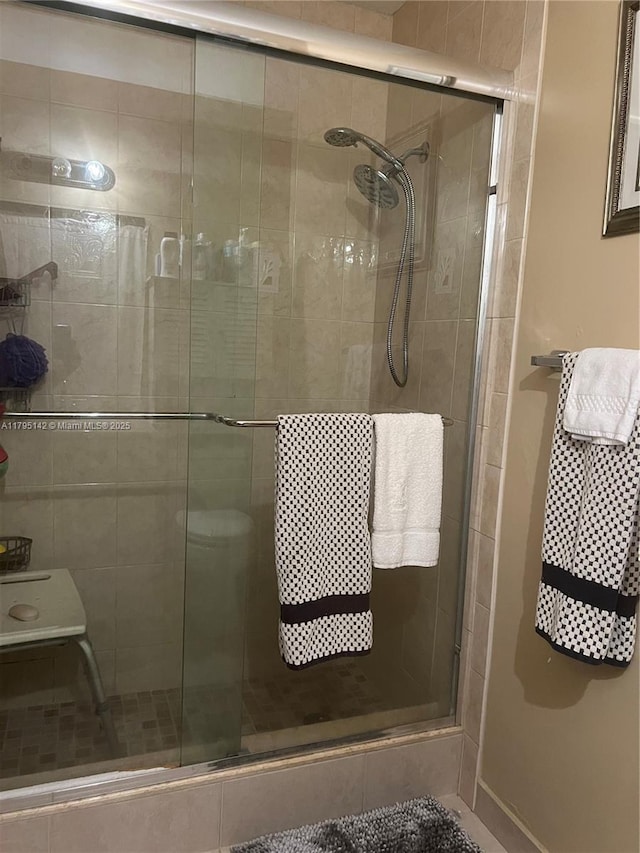 bathroom featuring baseboards and a stall shower