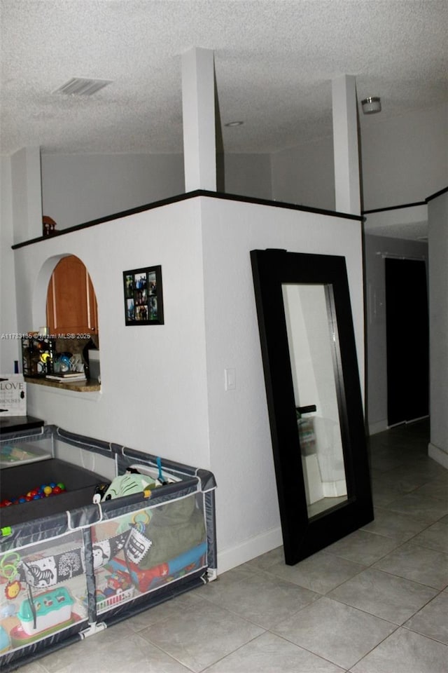 3638 NW 83rd Ln, Sunrise, FL 33351 - interior space with tile patterned floors, vaulted ceiling, a textured ceiling, and visible vents