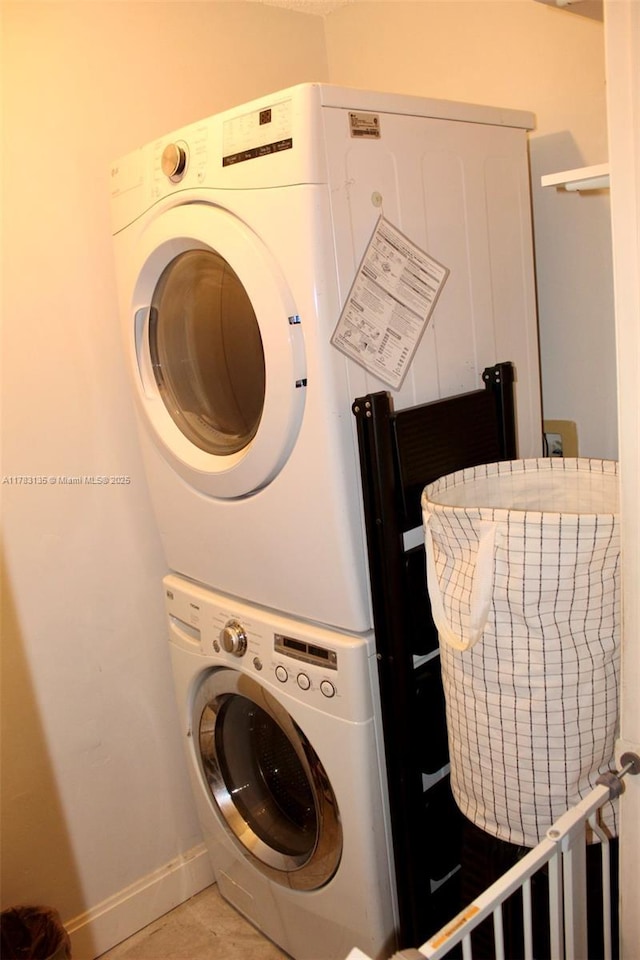3638 NW 83rd Ln, Sunrise, FL 33351 - clothes washing area featuring stacked washer / drying machine, baseboards, and laundry area