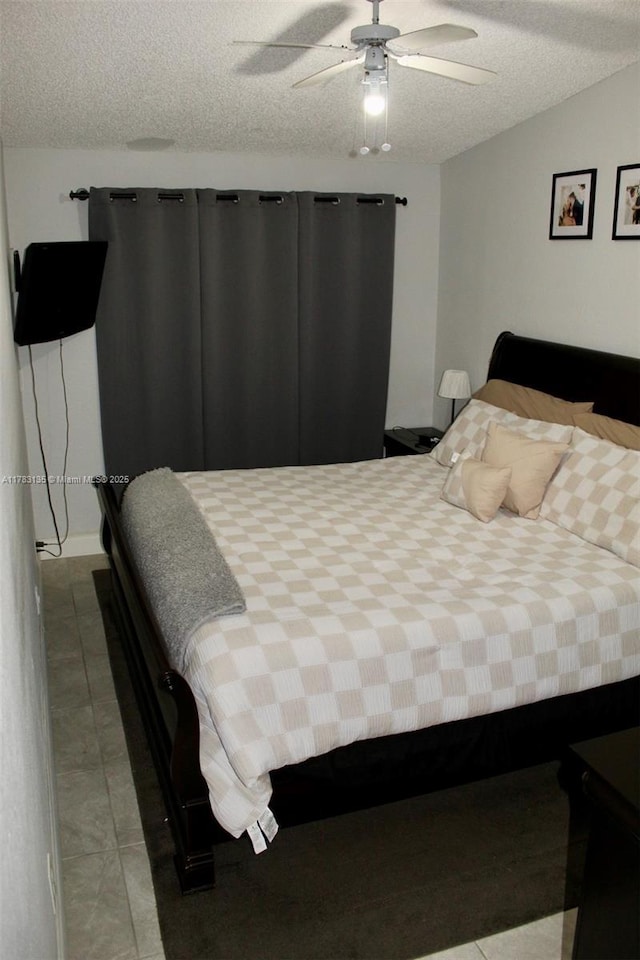 3638 NW 83rd Ln, Sunrise, FL 33351 - bedroom with a ceiling fan, a textured ceiling, and tile patterned floors