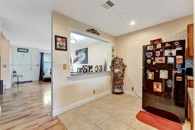 corridor with recessed lighting, baseboards, visible vents, and light wood finished floors