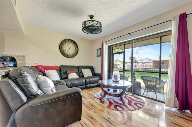 living area with a textured ceiling and wood finished floors