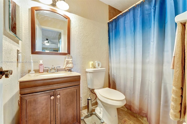 full bath featuring toilet, a textured wall, a shower with curtain, and vanity