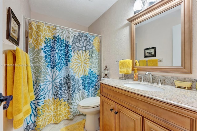 full bath with a textured wall, vanity, toilet, tile patterned floors, and a shower with shower curtain