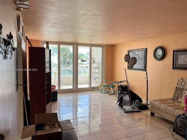 5005 Collins Ave Unit 214, Miami Beach, FL 33140 - living area featuring light tile patterned floors and a textured ceiling