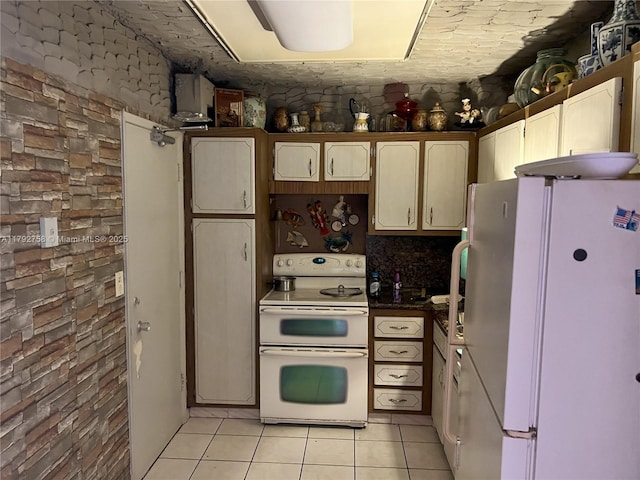 5005 Collins Ave Unit 214, Miami Beach, FL 33140 - kitchen with light tile patterned floors and white appliances