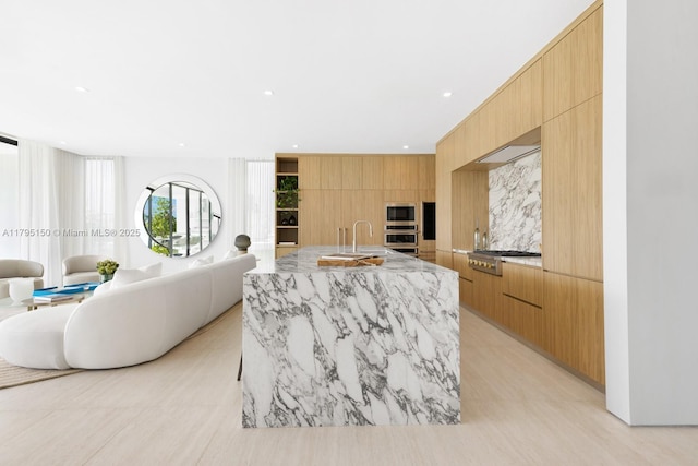 310 W Dilido Dr, Miami Beach, FL 33139 - kitchen with modern cabinets, stainless steel appliances, a sink, light stone counters, and recessed lighting
