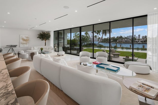 310 W Dilido Dr, Miami Beach, FL 33139 - living room with expansive windows, a water view, and recessed lighting