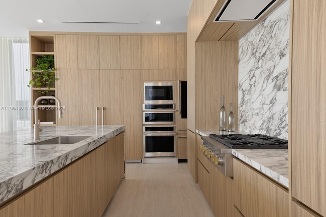 310 W Dilido Dr, Miami Beach, FL 33139 - kitchen featuring appliances with stainless steel finishes, a sink, modern cabinets, light brown cabinets, and recessed lighting