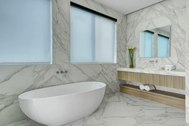 310 W Dilido Dr, Miami Beach, FL 33139 - full bath with marble tiled floors, a freestanding bath, vanity, and tile walls
