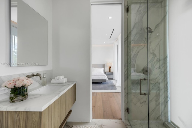 310 W Dilido Dr, Miami Beach, FL 33139 - ensuite bathroom featuring a marble finish shower, vanity, and wood finished floors