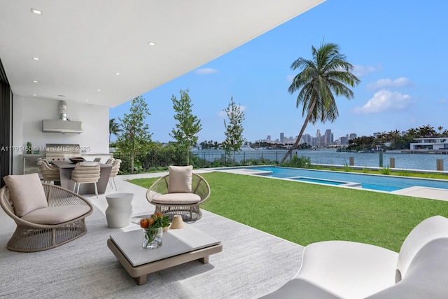 310 W Dilido Dr, Miami Beach, FL 33139 - view of patio / terrace with area for grilling, a pool with connected hot tub, a skyline view, and outdoor dining space