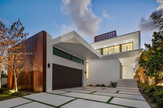 310 W Dilido Dr, Miami Beach, FL 33139 - contemporary house featuring concrete driveway and stucco siding