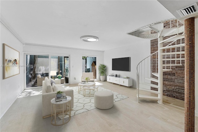 517 NE 38th St Unit 9, Miami, FL 33137 - living room featuring wood finished floors, stairs, ornamental molding, and baseboards