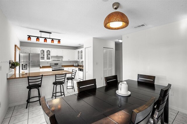 16080 SW 138th Pl, Miami, FL 33177 - dining room with baseboards and a textured ceiling