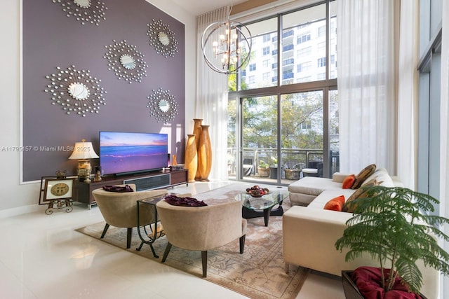 living room featuring a high ceiling, a notable chandelier, and baseboards