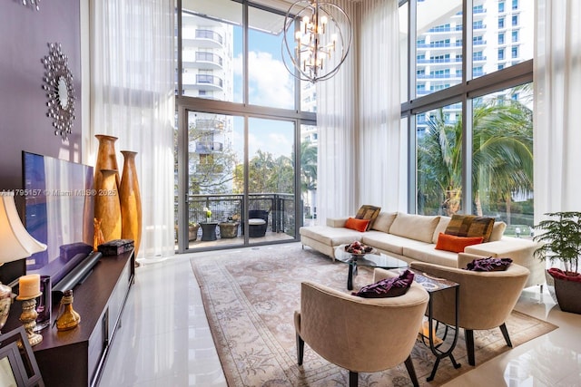 tiled living room featuring a chandelier, a wall of windows, and a towering ceiling