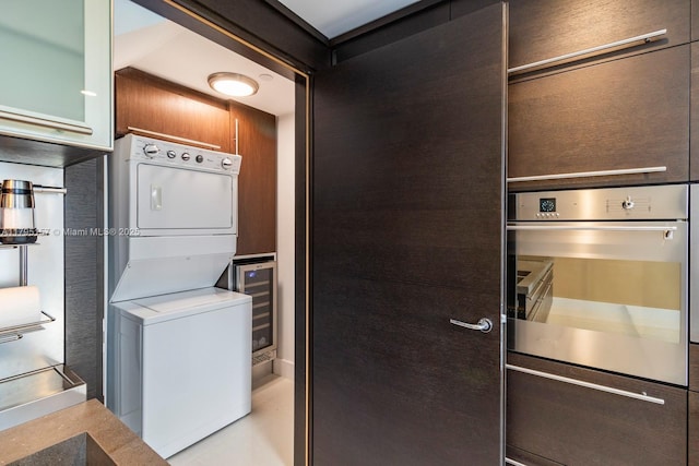 laundry room with stacked washer / drying machine and laundry area