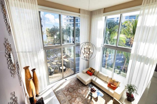 sunroom / solarium with a chandelier and a healthy amount of sunlight