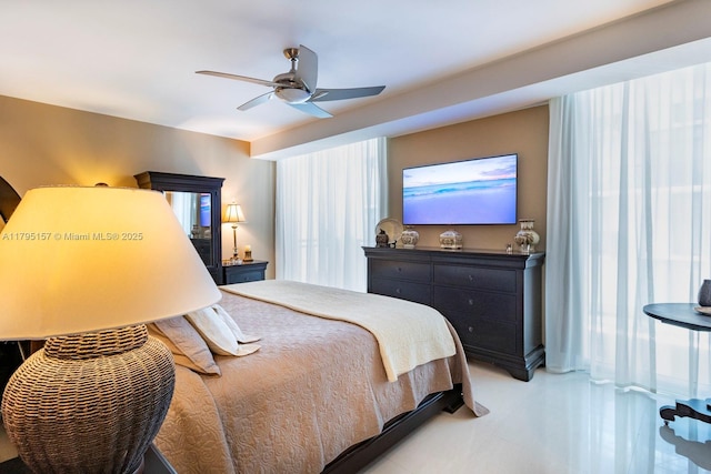 bedroom with ceiling fan and light tile patterned floors