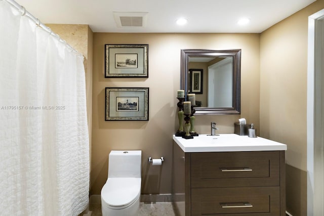 bathroom with toilet, baseboards, visible vents, and vanity
